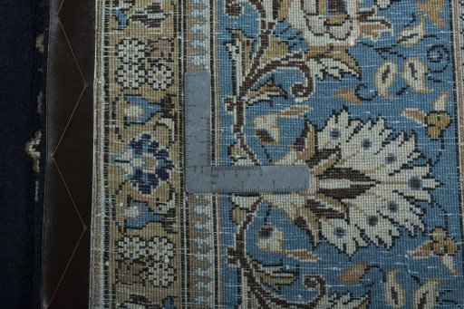 Backside of handmade 2000s Ghom rug showing knot structure and weave density