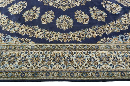 Corner detail of 2000s Ghom rug showing border pattern and Wool pile