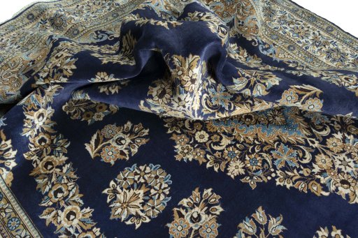Surface texture of 2000s Ghom rug with natural Wool and intricate pattern