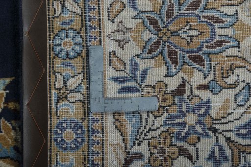 Backside of handmade 2000s Ghom rug showing knot structure and weave density