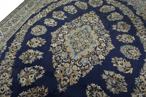 Backside of handmade 2000s Ghom rug showing knot structure and weave density