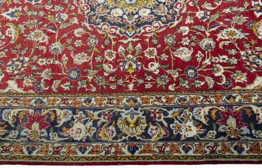Corner detail of 2000s Ghom rug showing border pattern and Wool pile