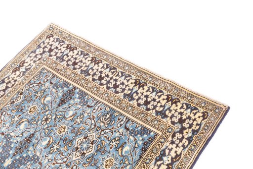 Surface texture of 1999s Ghom rug with natural Wool and intricate pattern