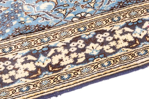 Backside of handmade 1999s Ghom rug showing knot structure and weave density