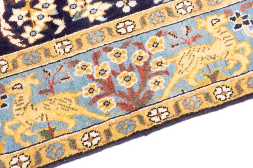 Backside of handmade 2001s Ghom rug showing knot structure and weave density