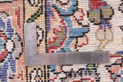 Corner detail of 1998s Ghom rug showing border pattern and Wool pile