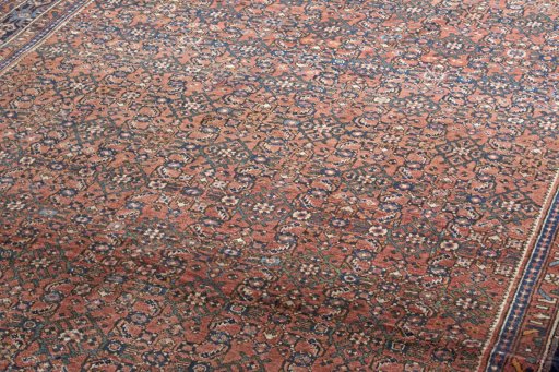 Surface texture of 2000s Hoseinabad rug with natural Wool and intricate pattern