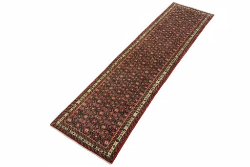 Corner detail of 2000s Hoseinabad rug showing border pattern and Wool pile