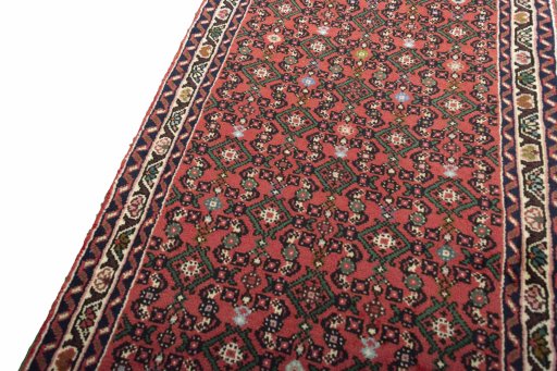 Backside of handmade New Hoseinabad rug showing knot structure and weave density