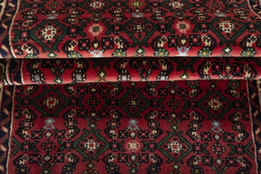 Full view of New Hoseinabad rug from Iran / Persia, 590 × 77 cm in Red tones