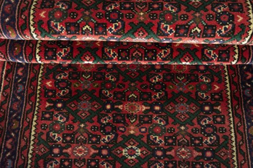 Full view of New Hoseinabad rug from Iran / Persia, 601 × 75 cm in Red tones