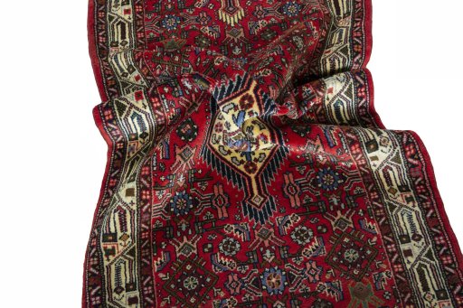 Corner detail of 2000s Hoseinabad rug showing border pattern and Wool pile