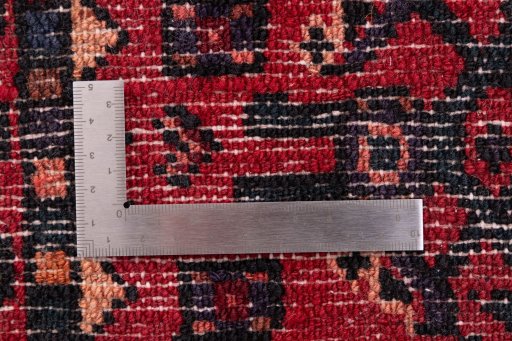 Corner detail of 2000s Hoseinabad rug showing border pattern and Wool pile