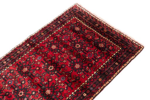 Surface texture of 2000s Hoseinabad rug with natural Wool and intricate pattern
