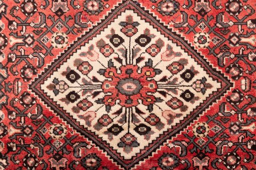 Full view of 1970s Hoseinabad rug from Iran / Persia, 228 × 156 cm in Terracotta tones
