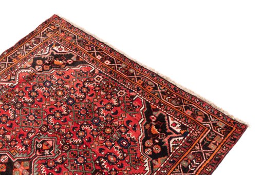 Surface texture of 1970s Hoseinabad rug with natural Wool and intricate pattern
