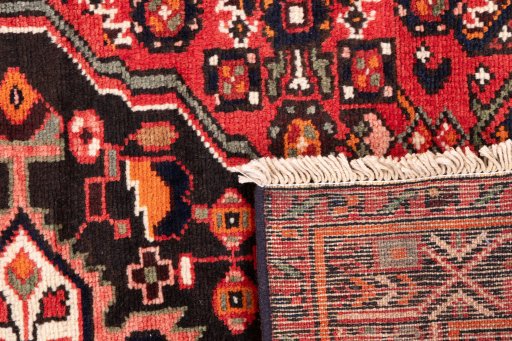 Close-up detail of 1970s Hoseinabad rug from Iran / Persia showing Wool weave