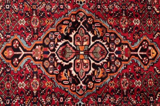 Full view of 1988s Hoseinabad rug from Iran / Persia, 216 × 160 cm in Red tones