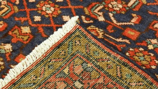 Close-up detail of 2000s Hoseinabad rug from Iran / Persia showing Wool weave