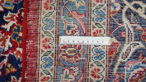 Corner detail of New Kashan rug showing border pattern and Wool pile