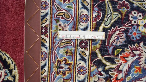 Corner detail of 1990s Kashan rug showing border pattern and Wool pile