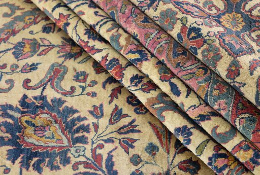 Corner detail of 1900s Kashan rug showing border pattern and Silk pile