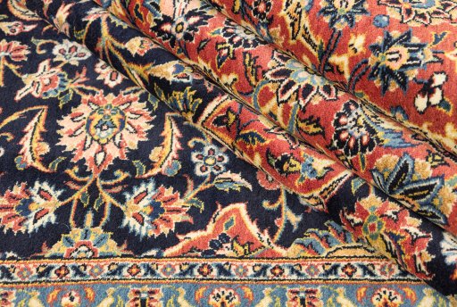 Corner detail of New Kashan rug showing border pattern and Wool pile