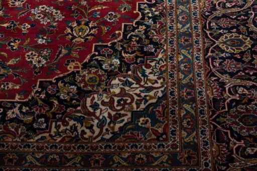 Corner detail of 2000s Kashan rug showing border pattern and Wool pile