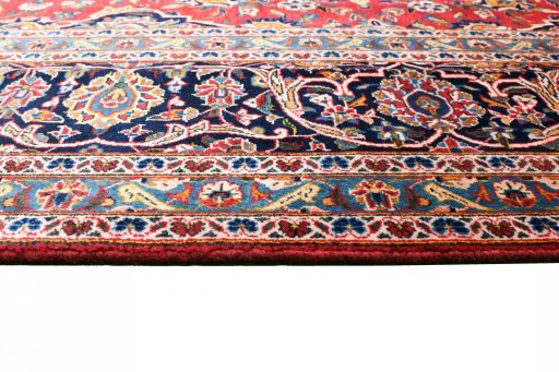 Corner detail of 2000s Kashan rug showing border pattern and Wool pile