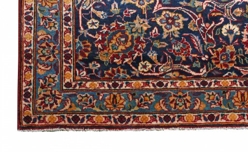 Backside of handmade 2000s Kashan rug showing knot structure and weave density