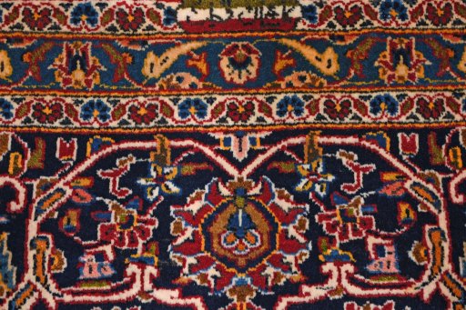 Backside of handmade 2000s Kashan rug showing knot structure and weave density