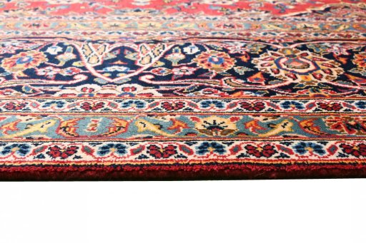 Corner detail of 2000s Kashan rug showing border pattern and Wool pile