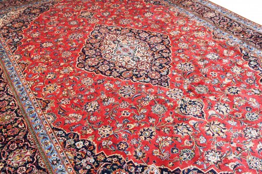 Corner detail of 2000s Kashan rug showing border pattern and Wool pile