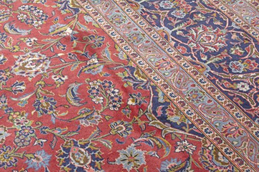 Backside of handmade New Kashan rug showing knot structure and weave density