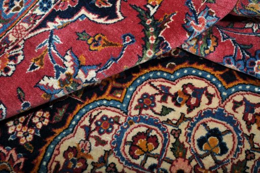 Corner detail of 1970s Kashan rug showing border pattern and Wool pile