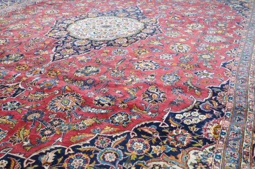 Backside of handmade 1970s Kashan rug showing knot structure and weave density
