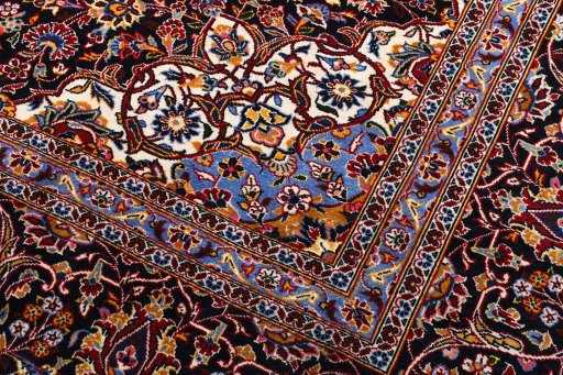 Corner detail of 2000s Kashan rug showing border pattern and Wool pile