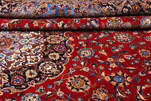 Corner detail of 2000s Kashan rug showing border pattern and Wool pile