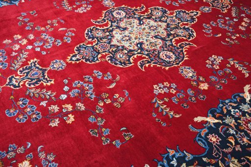 Backside of handmade 2000s Kashan rug showing knot structure and weave density