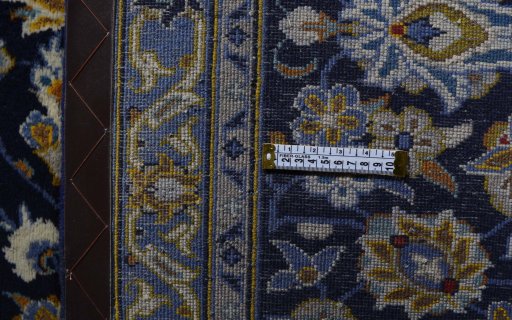 Corner detail of 2000s Kashan rug showing border pattern and Wool pile