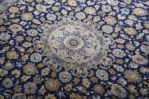 Backside of handmade 2000s Kashan rug showing knot structure and weave density