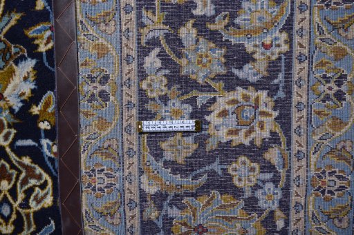 Corner detail of 2000s Kashan rug showing border pattern and Wool pile