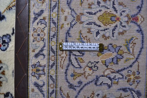 Corner detail of 2000s Kashan rug showing border pattern and Wool pile