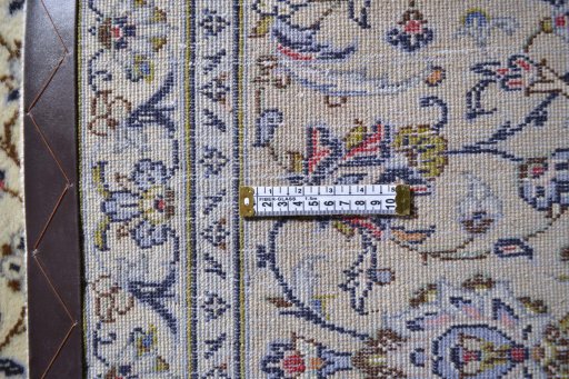 Corner detail of 2000s Kashan rug showing border pattern and Wool pile