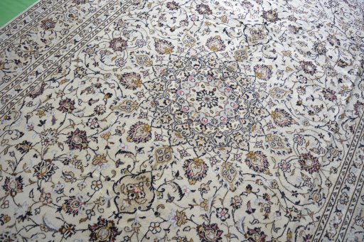 Backside of handmade 2000s Kashan rug showing knot structure and weave density