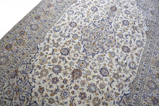 Backside of handmade 2000s Kashan rug showing knot structure and weave density