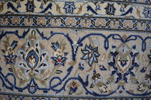 Backside of handmade 2000s Kashan rug showing knot structure and weave density