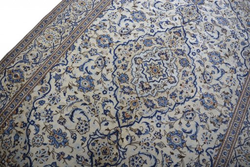Backside of handmade 2000s Kashan rug showing knot structure and weave density