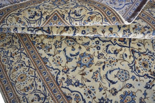 Corner detail of 2000s Kashan rug showing border pattern and Wool pile