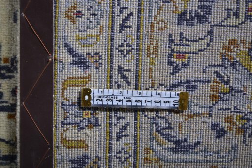 Corner detail of 2000s Kashan rug showing border pattern and Wool pile